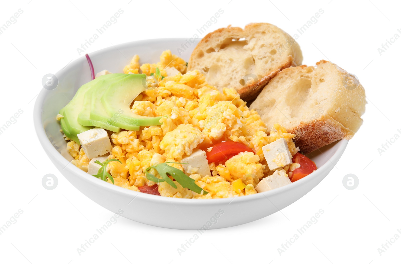 Photo of Bowl with delicious scrambled eggs, tofu, avocado and slices of baguette isolated on white