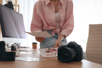Photo of Professional photographer working in light modern office, closeup