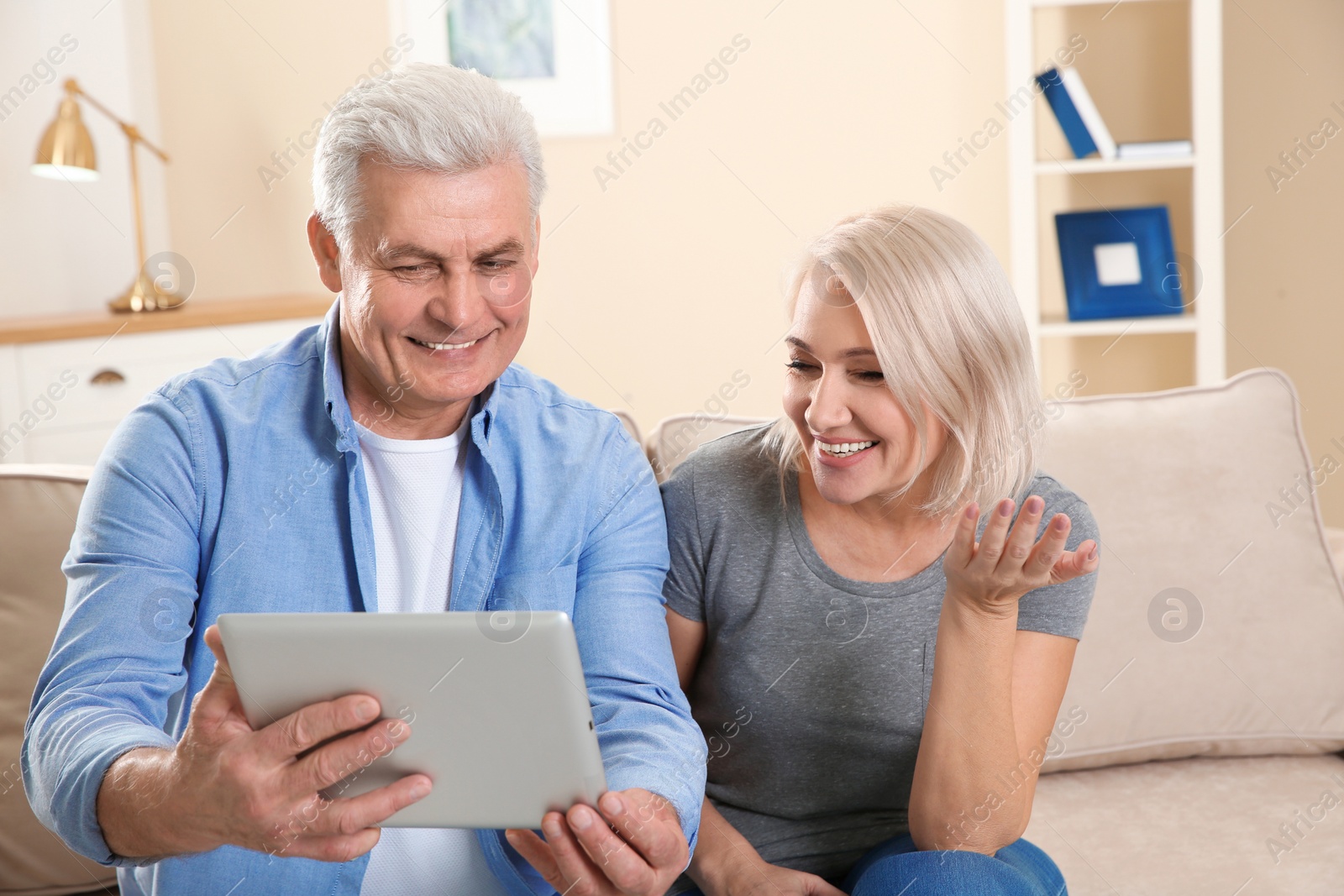 Photo of Mature couple using video chat on tablet at home