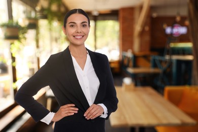 Image of Portrait of hostess wearing uniform in cafe. Space for text