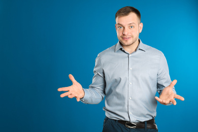 Photo of Portrait of happy young man on blue background