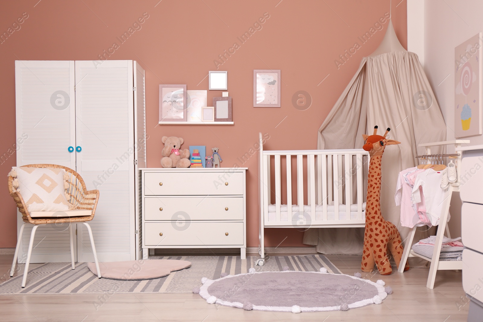 Photo of Baby room interior with stylish furniture and comfortable crib