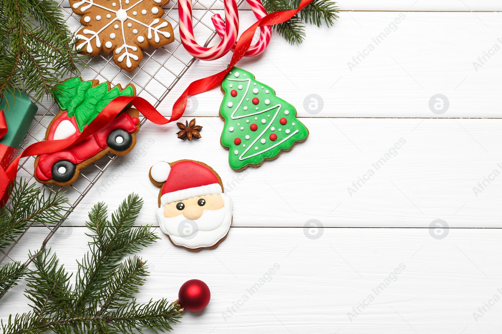 Photo of Tasty homemade Christmas cookies and decor on white wooden table, flat lay. Space for text