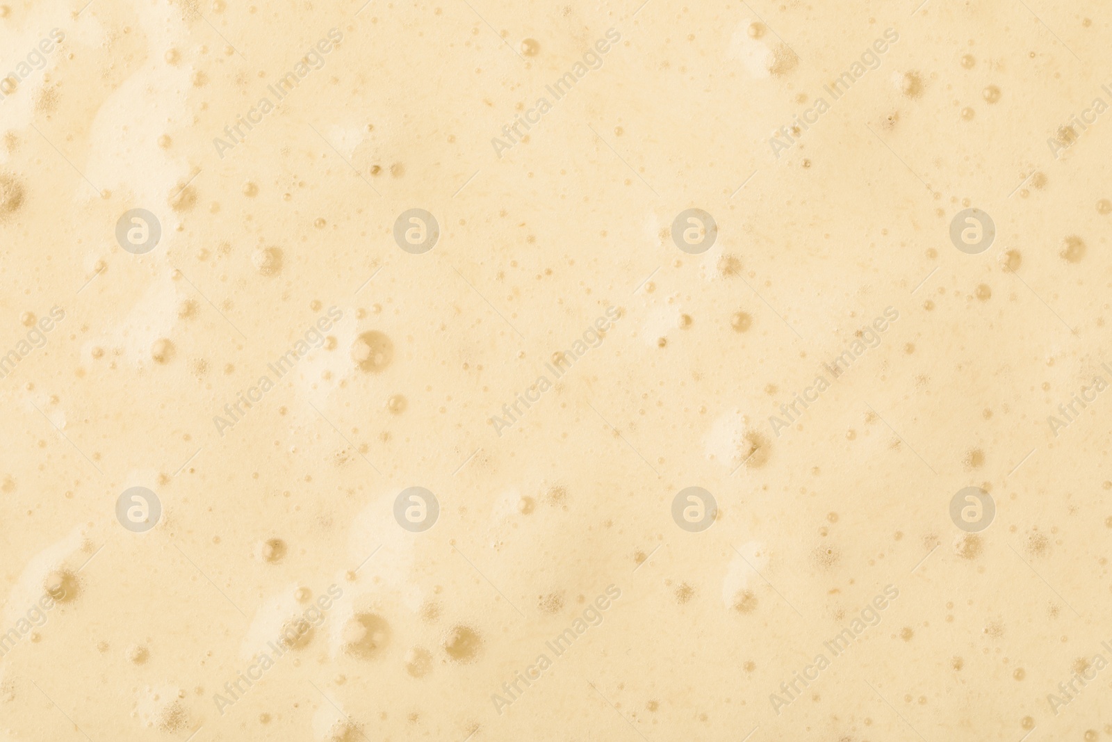 Photo of Tasty smoothie with bubbles as background, closeup