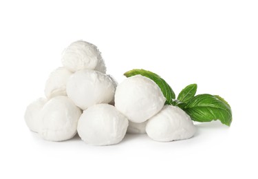 Photo of Delicious mozzarella cheese balls and basil on white background