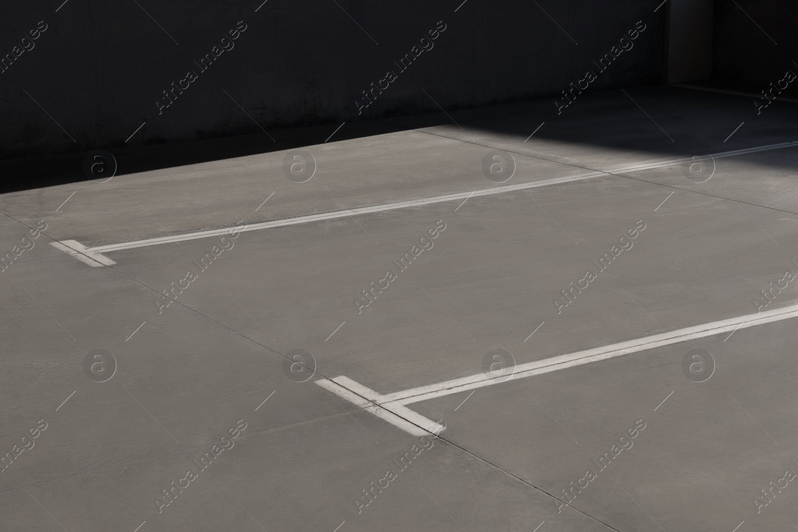 Photo of Outdoor car parking lot with white marking lines