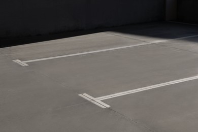 Photo of Outdoor car parking lot with white marking lines