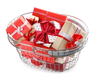 Photo of Shopping basket full of gift boxes on white background