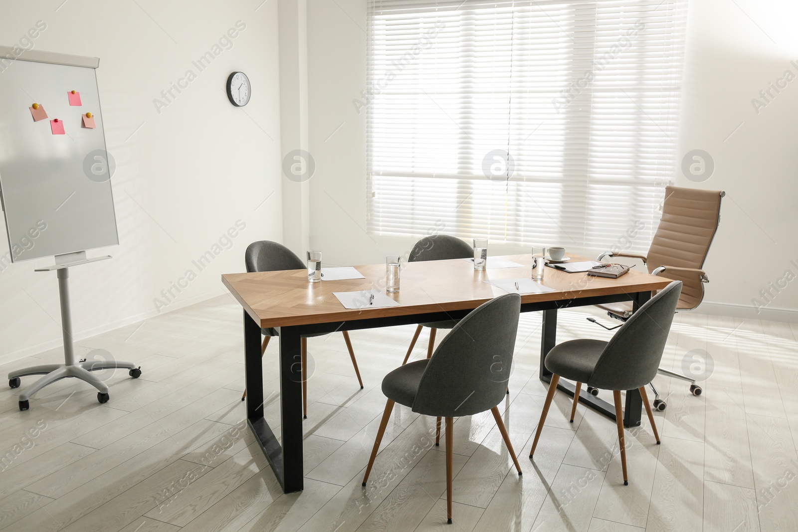 Photo of Simple office interior with large table and chairs