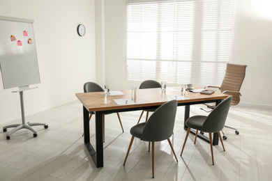 Photo of Simple office interior with large table and chairs
