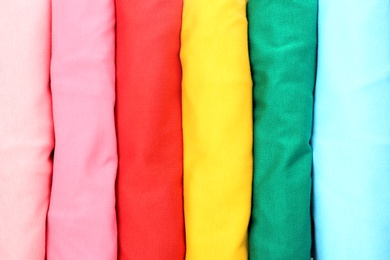 Photo of Many trendy colorful t-shirts, close up view