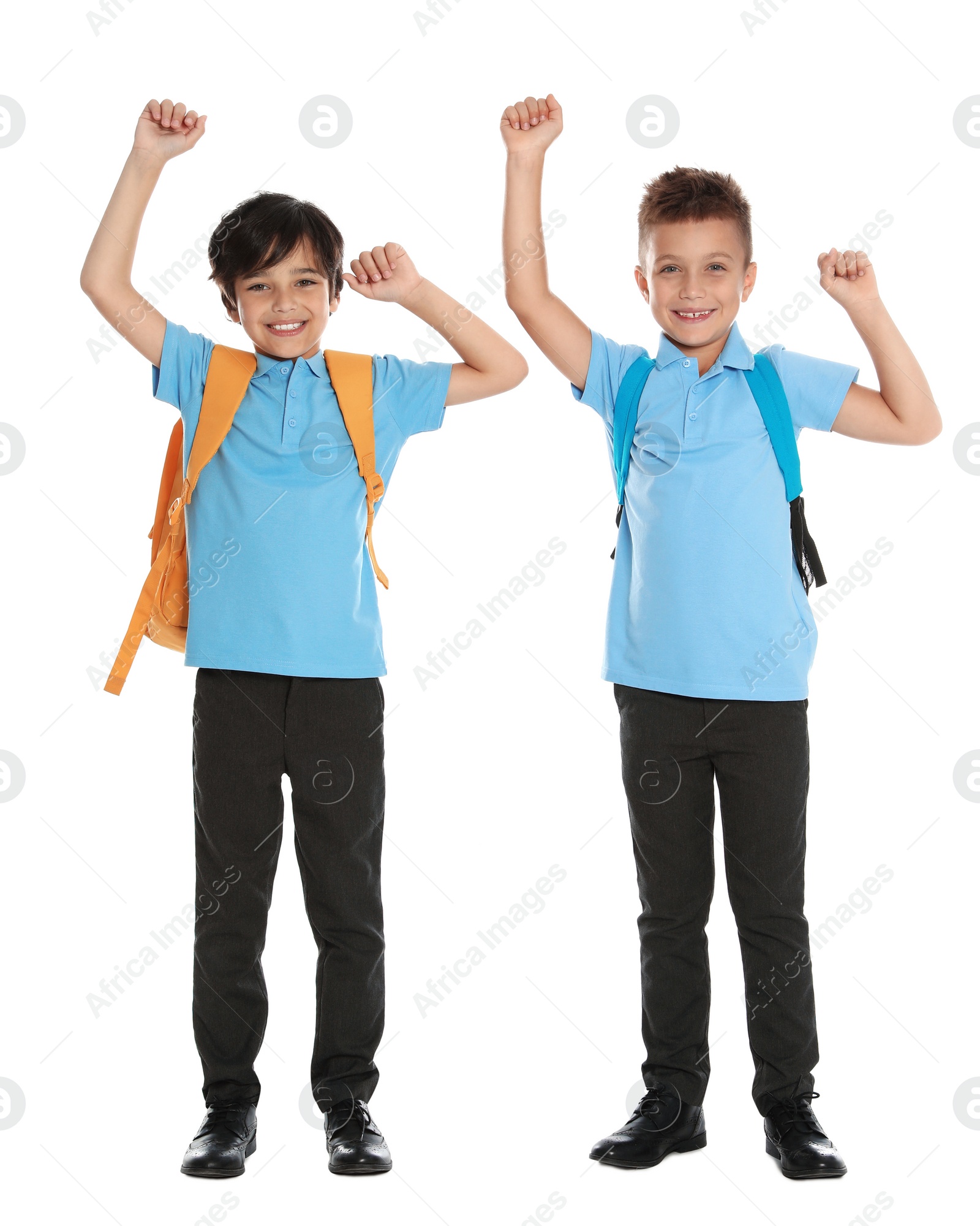 Photo of Happy boys in school uniform on white background