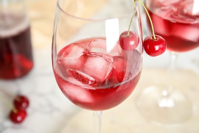 Delicious cherry wine with ripe juicy berries on table, closeup