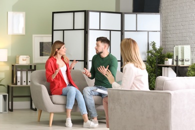 Photo of Young couple with problem at family psychologist office