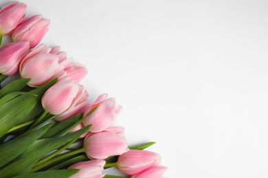 Photo of Beautiful pink spring tulips on white background, top view