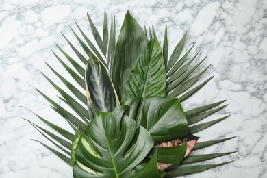 Flat lay composition with tropical leaves on marble background