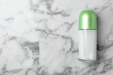 Photo of Deodorant on marble background, top view. Skin care