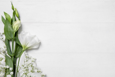 Photo of Beautiful flowers on white wooden background, flat lay. Space for text