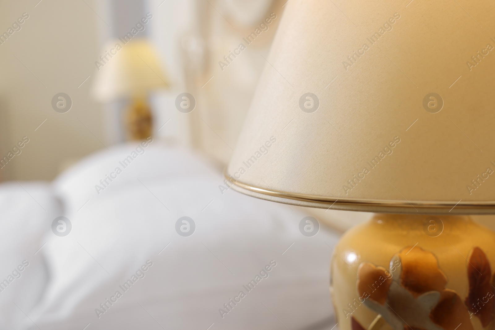 Photo of Stylish lamp in bedroom, closeup. Space for text