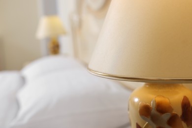 Photo of Stylish lamp in bedroom, closeup. Space for text