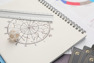 Photo of Zodiac wheel, ruler and dice on table, closeup. Astrological predictions