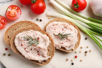Sandwiches with delicious lard spread and vegetables on board, flat lay