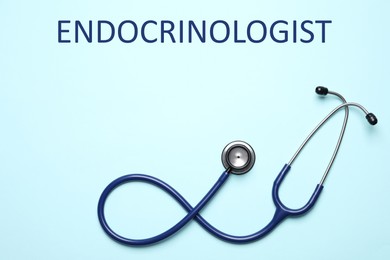 Endocrinologist. Stethoscope on light blue background, top view