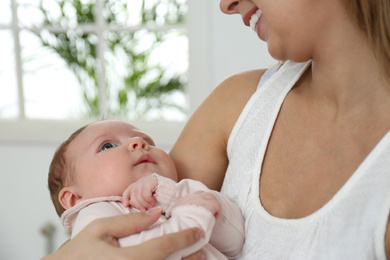 Photo of Young woman with her little baby resting after breast feeding at home, closeup