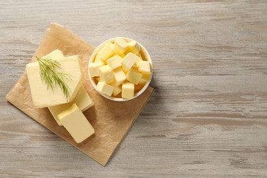 Photo of Tasty butter with dill on wooden table, top view. Space for text