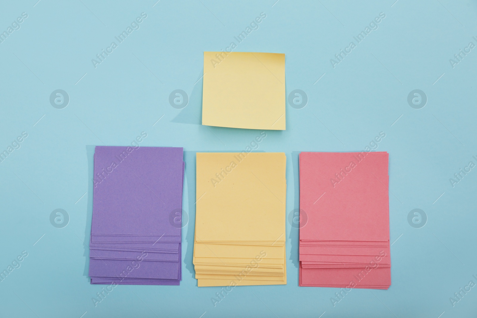 Photo of Colorful sticky notes on light blue background, flat lay