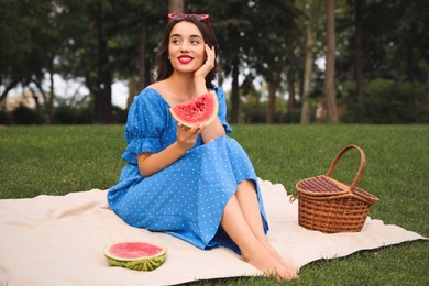 Photo of Beautiful young woman with watermelon in park on sunny day