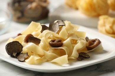 Photo of Tasty tagliatelle with truffle on table, closeup