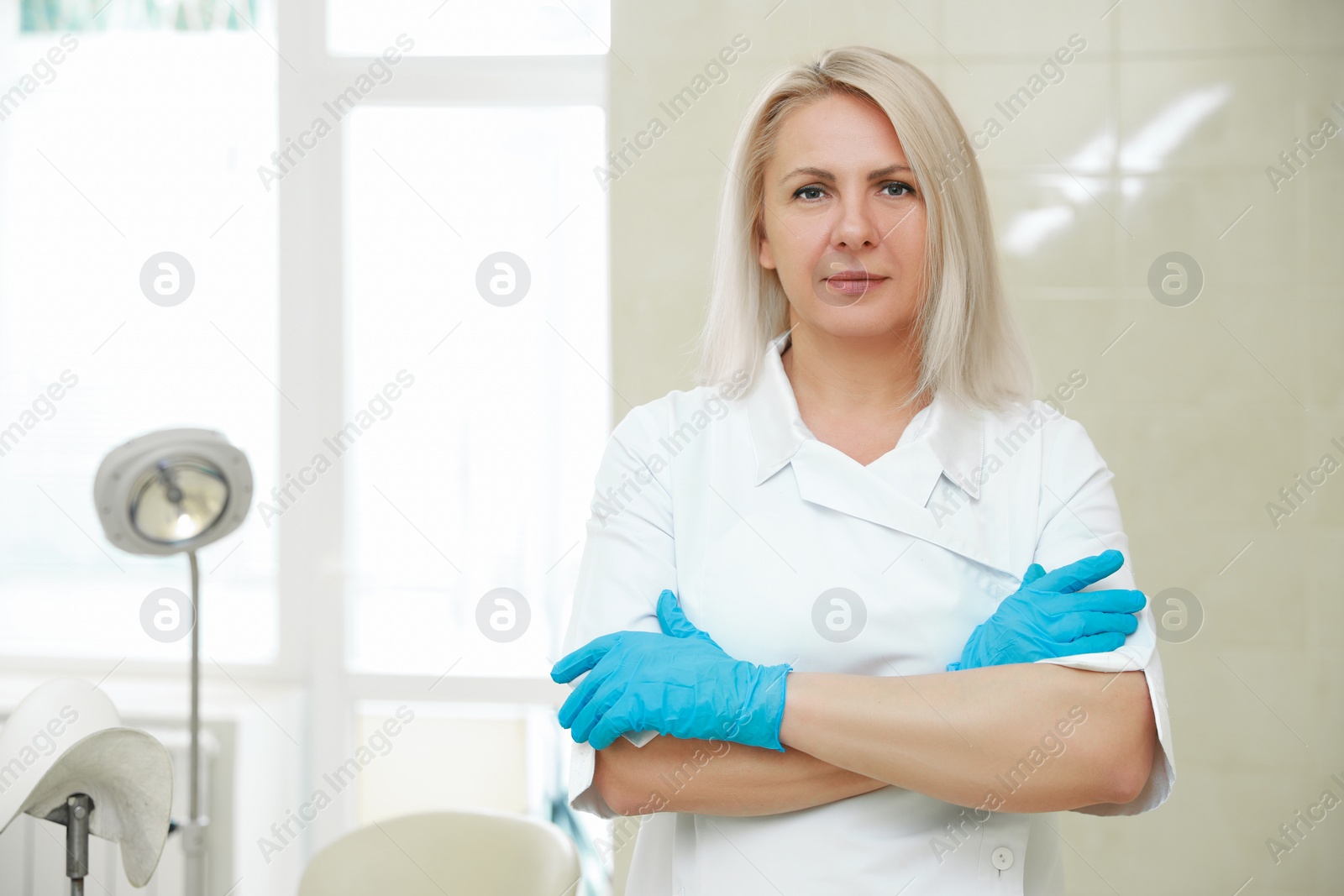 Photo of Portrait of gynecologist at workplace in clinic. Space for text