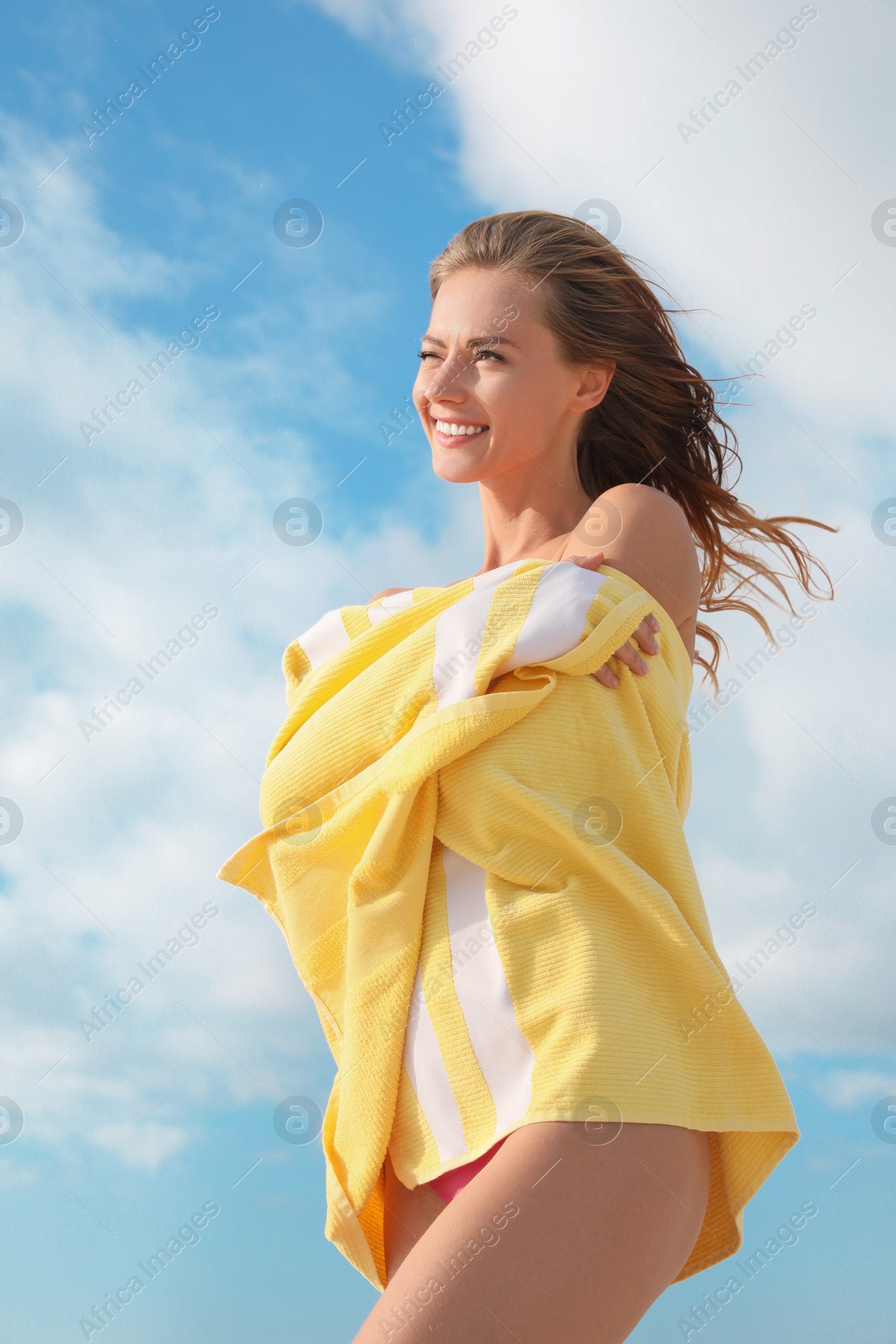 Photo of Beautiful woman with beach towel against sky