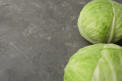 Photo of Ripe white cabbage on grey table, closeup. Space for text