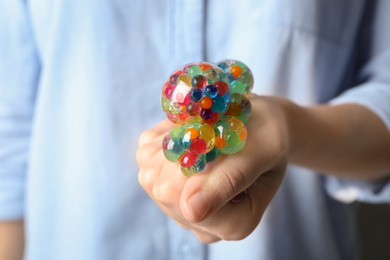 Woman squeezing colorful slime, closeup. Antistress toy