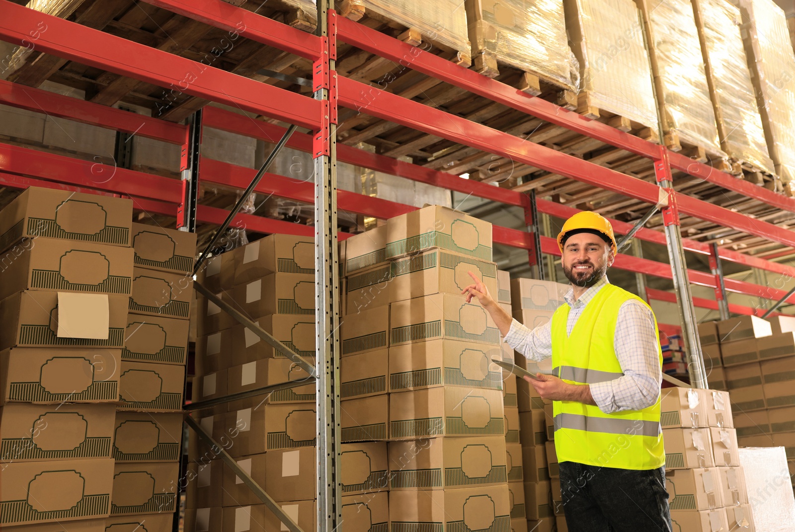 Image of Man with tablet working at warehouse. Logistics center