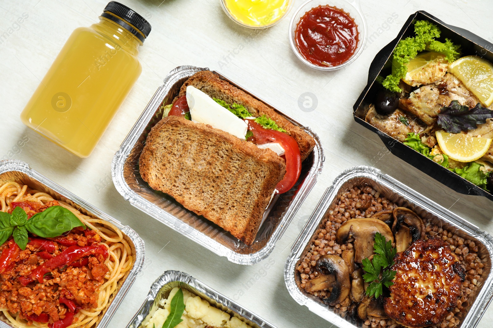 Photo of Lunchboxes on white wooden table, flat lay. Healthy food delivery