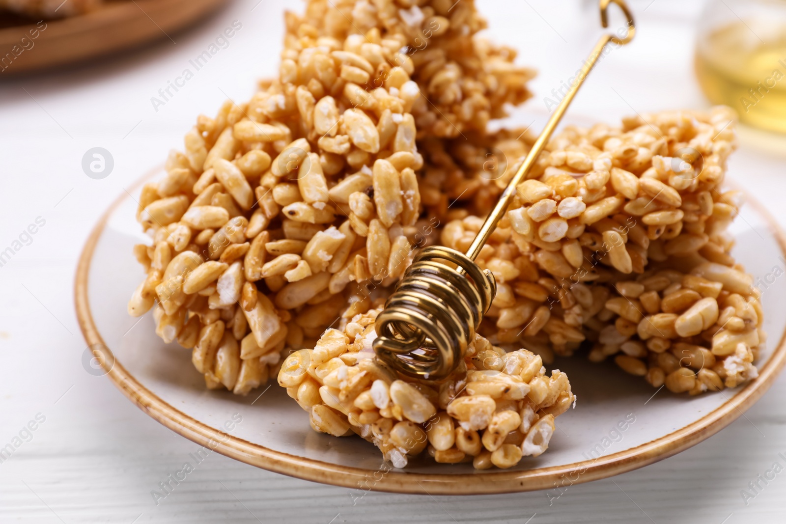 Photo of Puffed rice bars (kozinaki) on white plate, closeup