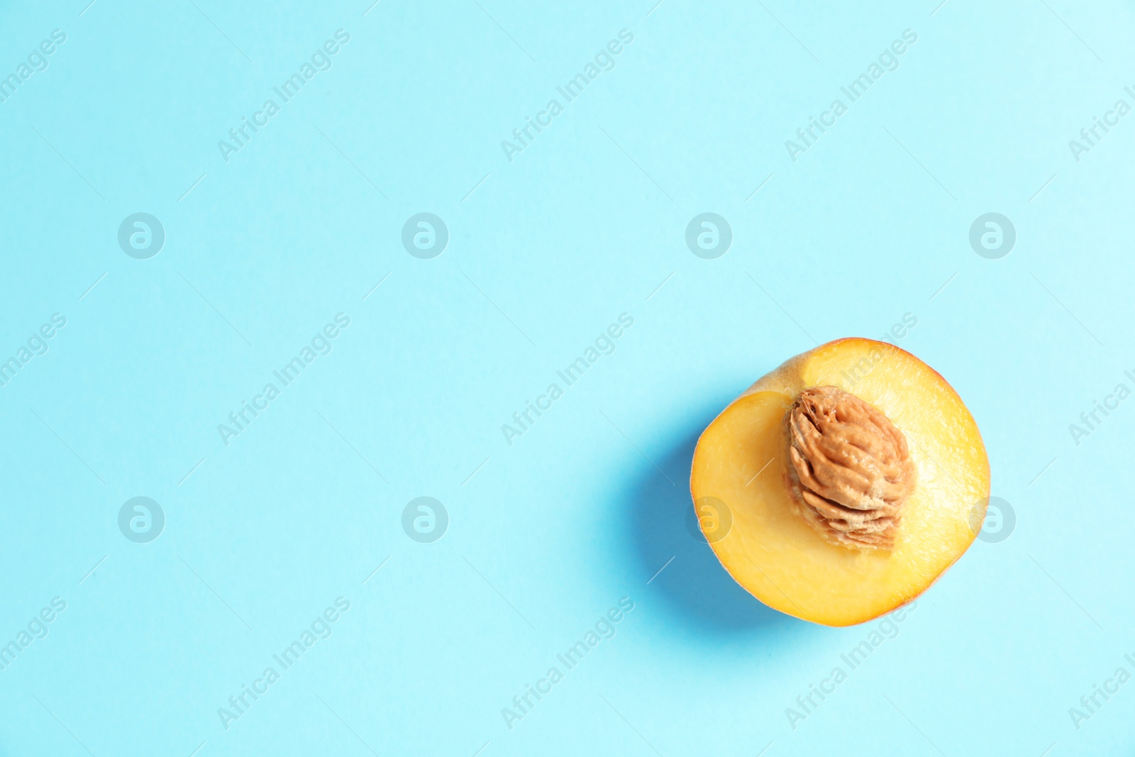 Photo of Half of fresh sweet peach on color background, top view