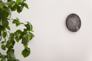 Analog clock hanging on wall. Time of day