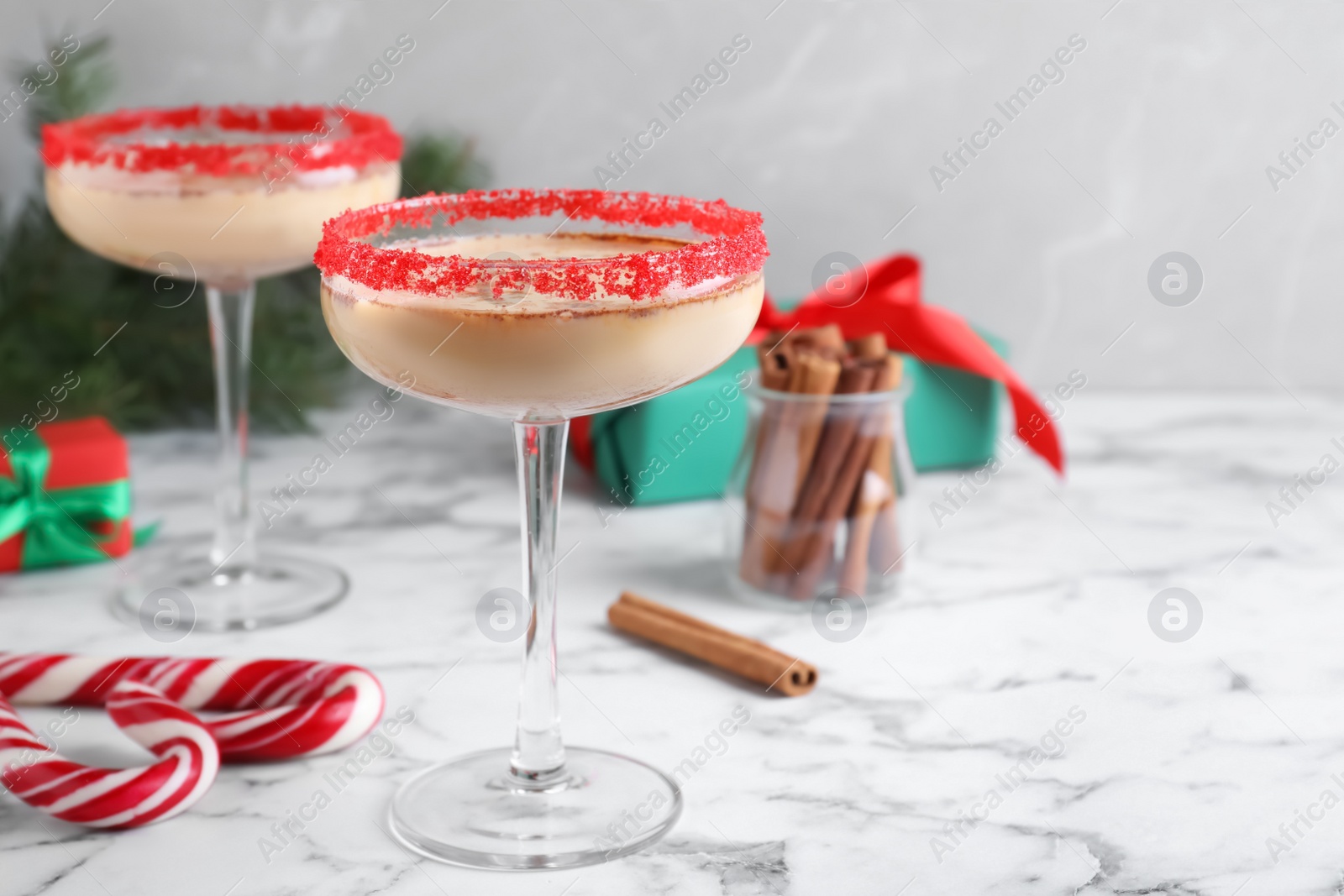 Photo of Delicious Christmas liqueur on white marble table, space for text