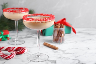 Photo of Delicious Christmas liqueur on white marble table, space for text