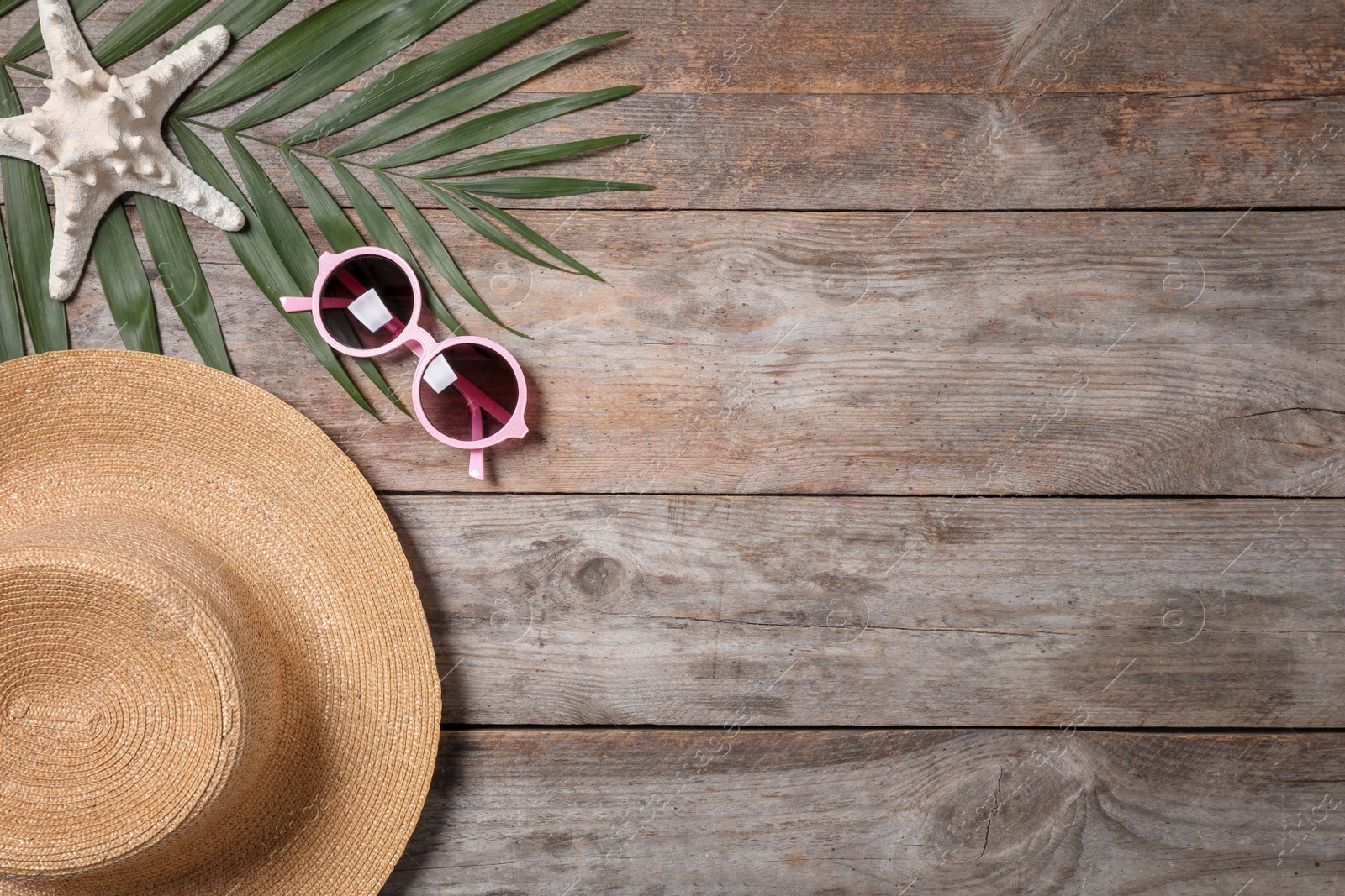 Photo of Flat lay composition with hat and sunglasses on wooden background. Beach objects