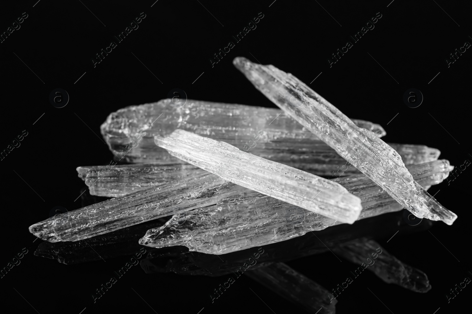 Photo of Menthol crystals on black background, closeup view