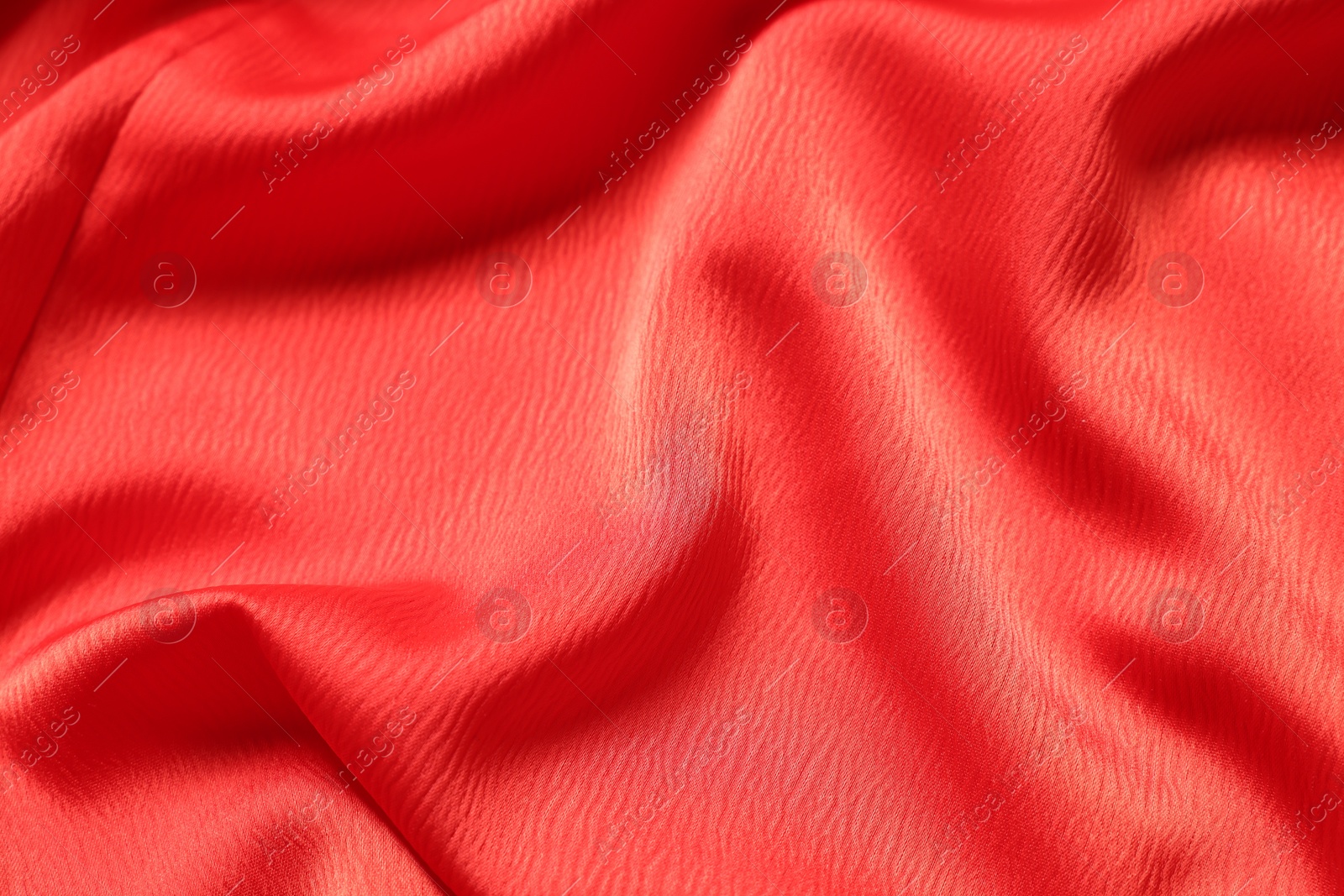 Photo of Texture of red crumpled fabric as background, top view