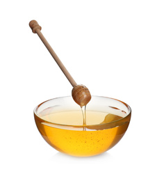 Honey dripping from wooden dipper into bowl isolated on white