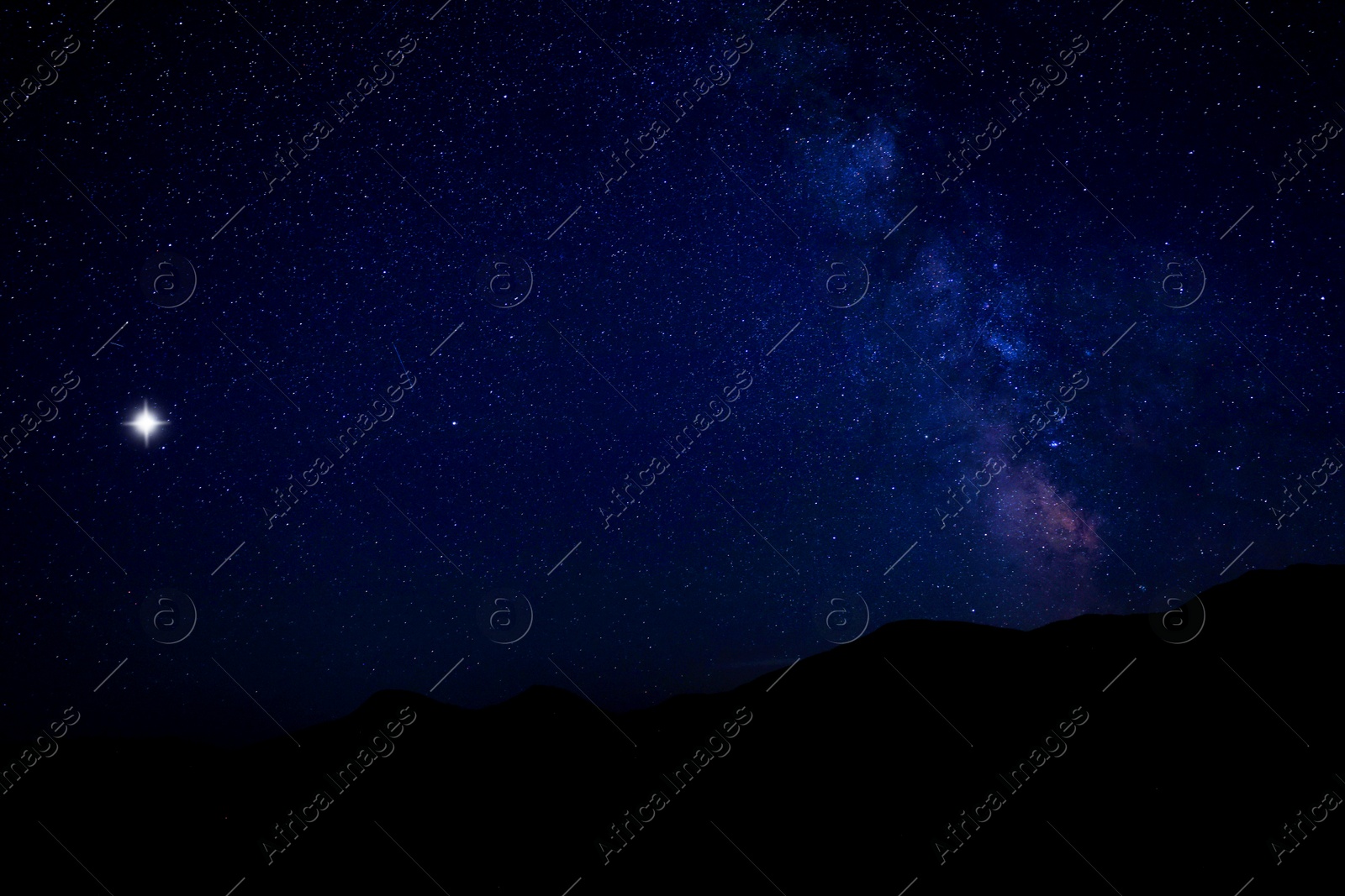 Image of Sky with twinkling stars over mountains at night