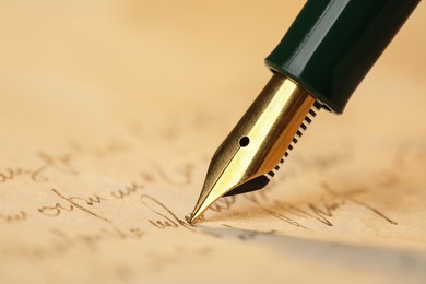 Photo of Writing letter with beautiful fountain pen, closeup