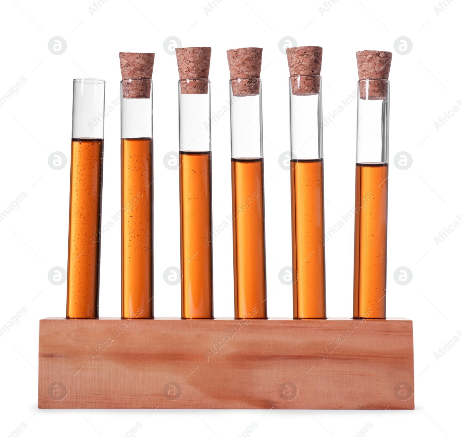 Photo of Test tubes with brown liquid in stand on white background